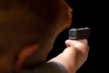 Young White Caucasian Kid Child Boy Holding and Aming Handgun Shooting