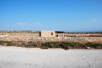 Summer house. Lampedusa, Italy. Street, land, sky.