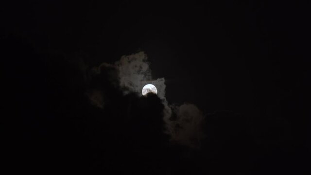 Beautiful full moon, behind the clouds. Brazil, fall.
