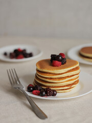 Sweet Homemade Stack of Pancakes with Butter, berries and Syrup for Breakfast 