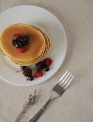 Sweet Homemade Stack of Pancakes with Butter, berries and Syrup for Breakfast 