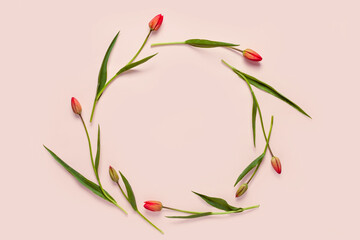 Floral background. Round frame wreath with tulips. Composition made of tulips on pink background....