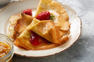 Breakfast french crepes with strawberry jam