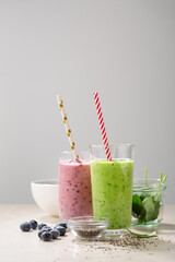 Two glasses of summer cold beverages, blended fruits and chia seeds
