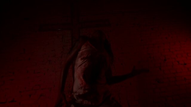 dance of exorcism a girl in bloodstained clothes moves against the background of a cross
