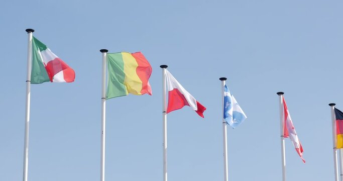 Italy, Poland, Mali, Quebec and Canada flags on pole in la flèche, France, 10.4.2021 Italian, Polish, Malian, Quebecois and Canadian flags waving on pole