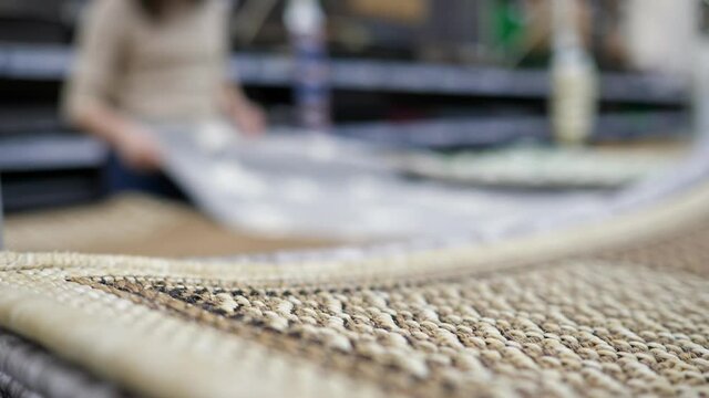 unrecognizable woman in carpet store blurred background.
