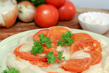 homemade pie with fresh tomatoes and mozzarella