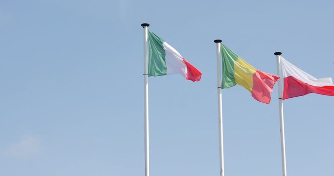 Italy, Poland and Mali flags on pole in la flèche, France, 10.4.2021 Italian, Polish and Malian flags waving on pole