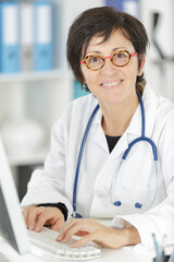 a mature female doctor smiling at the camera