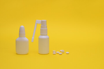 Medical nasal spray for flu and cold treatment and pills. Healing of diseases of the throat and nose. On a yellow background. space for writing