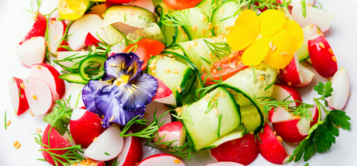 Spring vegetable salad with flowers,close up