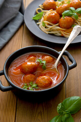 Meatballs with tomato sauce on wooden background, delicious mediteranean food