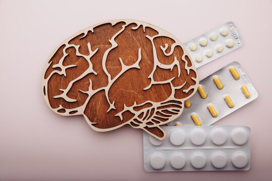 Brain And Pills Isolated On Pink Background. Dementia Concept