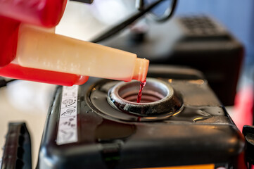 adding winter stabilizer fuel additive to a snow blower gas tank