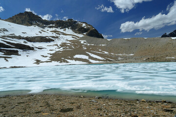 Iceline loop hiking trail with snow covered blue colour lake in Yoho National Park, popular tourist summer hike, Canadian Rockies, British Columbia, Canada