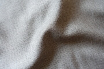 Soft fold on grey fabric with dupplins checks