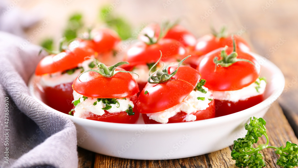 Wall mural cherry tomato garnish with cream cheese and herbs