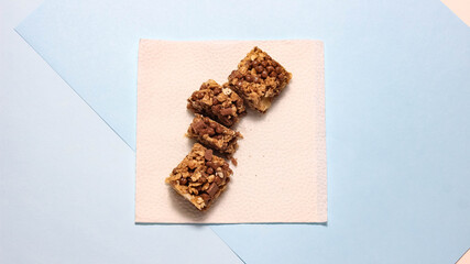 Energy bar on a paper napkin, cut into pieces.