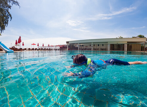 Happy young boy swim - Powered by Adobe