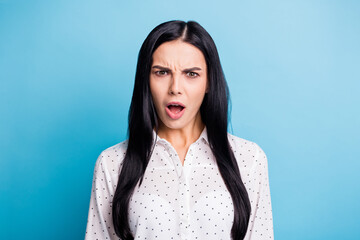 Photo of unhappy shocked young woman astonished fake negative news isolated on pastel blue color...