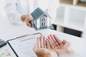 home loan insurance. .Real estate broker and client  sign contract insurance agreement document....