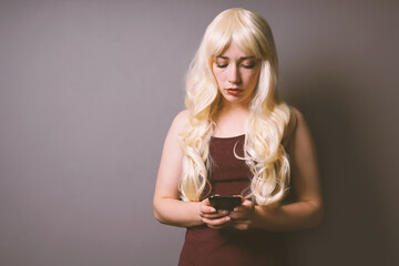 serious young woman using smartphone reading bad news text message