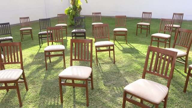 Elegant garden Chairs Set Up On A Green Lawn For An Event.