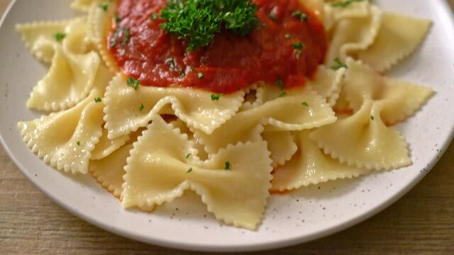 farfalle pasta in tomato sauce with parsley - Italian food style