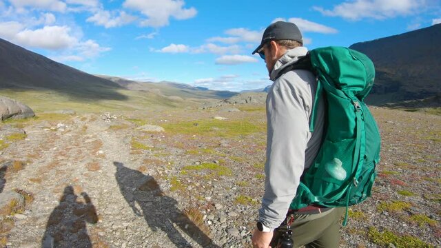 Close-up of a male hiker walking in the nature of Northern Sweden.