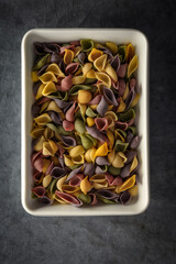 Dark Food Photography Pasta on white dish, dark background, text space.