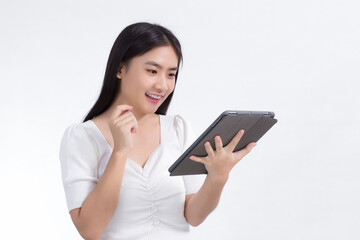 Fototapeta premium Asian beautiful woman in white shirt look at on tablet in her hand excitedly on white background.