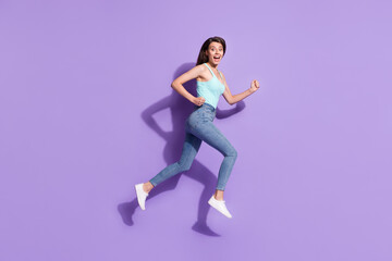 Full size profile photo of astonished attractive lady running open mouth look camera isolated on violet color background