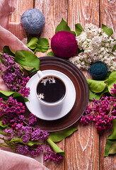 Coffee Cup And Colorful Lilac Flowers On Garden wooden Table