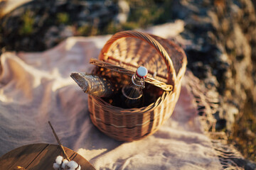 Set for romantic picnic at nature. Basket with baguette wine.