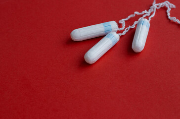 Ladies Feminine Hygiene Product On A Red Background. Concept photo for women's or feminist blog. . High quality photo. Hygiene products for monthly menstruation. close-up on a red paper surface.