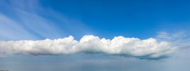 Blue sky background with a huge fluffy clouds