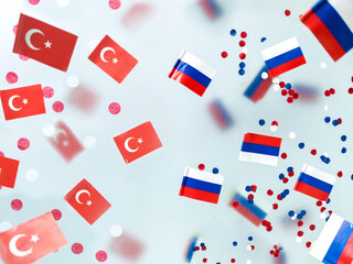 Turkey vs. Russia. Air travel ban, flight cancellations, covid pandemic. Mini flags on a foggy background.