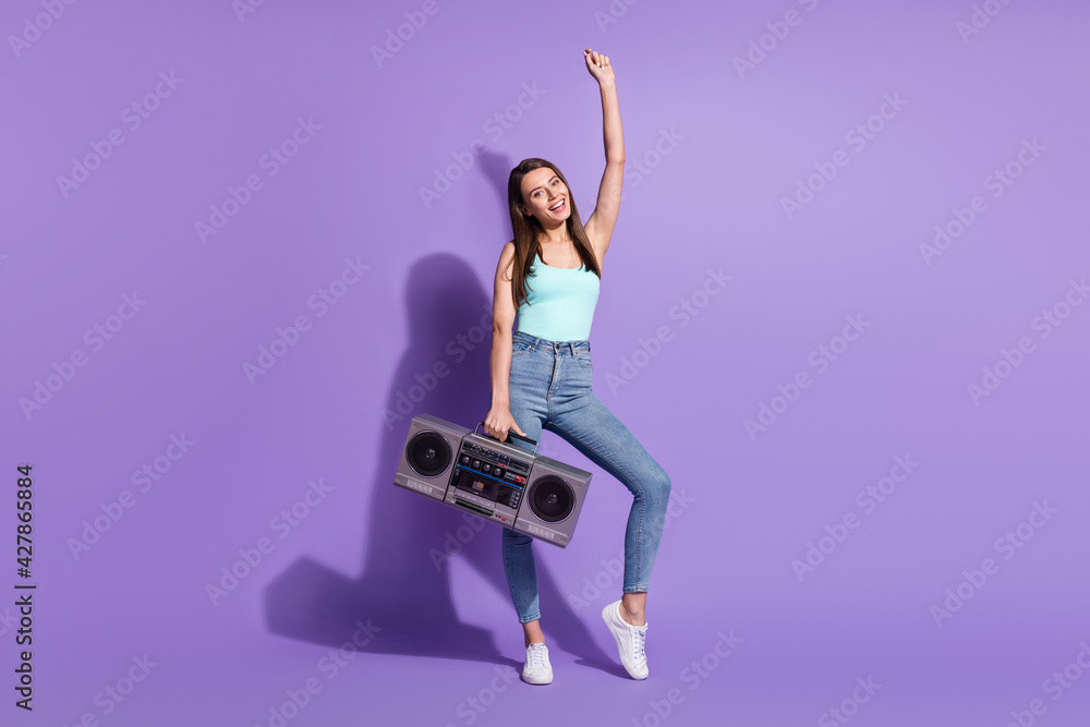 Sticker Full size photo of young charming positive good mood smiling girl hold boombox isolated on violet color background