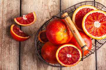 Blood oranges in a metal basket.