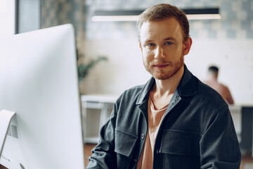 Portrait of a young smart businessman in modern office