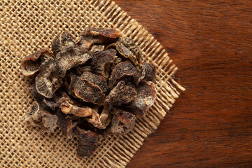 closeup of Organic Dried gooseberry or Amla (Ribes grossularia) on the wooden top background and jute mat.