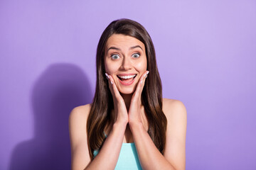 Fototapeta premium Photo of pretty charming amazed young woman hold hands cheekbones surprise isolated on violet color background