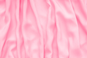 Abstract background, silk texture luxury light pink fabric with wavy folds.