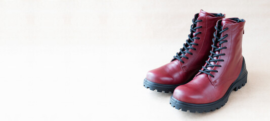 Beautiful burgundy women's shoes on kraft background, banner
