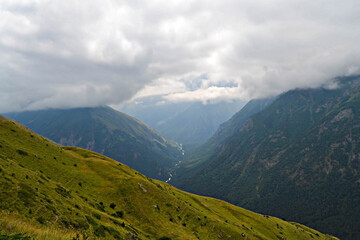 Fototapeta na wymiar Landscape with clouds in the majestic mountains of the Caucasus. Kabardino-Balkaria. Tegenekli.