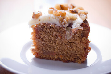 A piece of carrot cake with nuts
