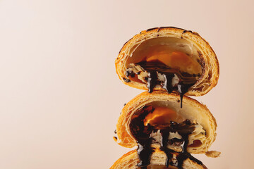 Texture of crispy puff croissants with liquid flowing chocolate. Background with copy space