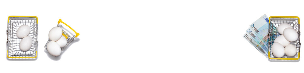 Basket and cart with fresh white eggs and another basket full of white eggs with euro bills...