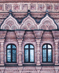 The windows of an ancient red brick church